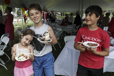 a group of kids holding plates of ice cream