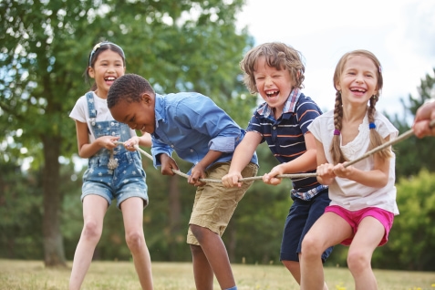 a group of kids playing tug of war
